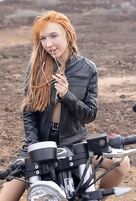 Lilly Mays Rides A Motorcycle In The Desert Wearing A Leather Jacket And Miniskirt