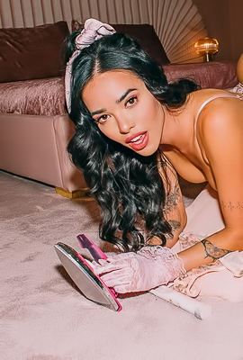 Jessica Vaugn shows off tattoos from top to bottom in her pearl necklace